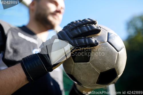 Image of close up of goalkeeper with ball playing football