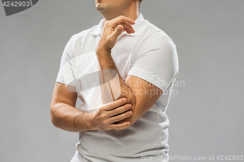 Image of close up of man suffering from pain in hand