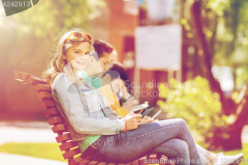 Image of happy girl with tablet pc computer outdoors