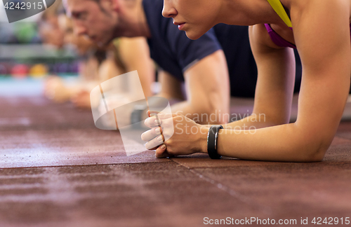 Image of group of people exercising in gym