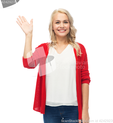 Image of happy smiling young woman waving hand over white