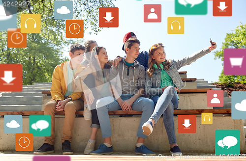 Image of happy teenage students taking selfie by smartphone