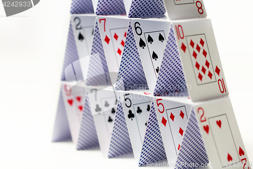 Image of house of playing cards over white background