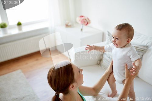 Image of happy young mother with little baby at home