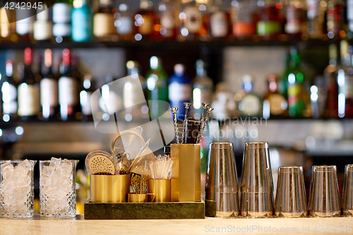 Image of shakers, glasses, stirrers and strainers at bar