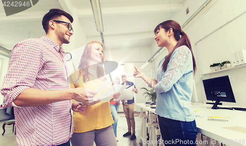 Image of creative team on coffee break talking at office