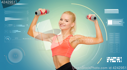 Image of happy young sporty woman exercising with dumbbells