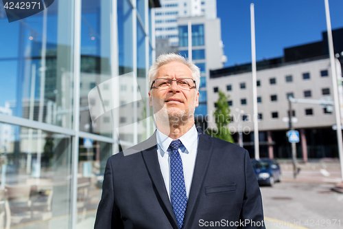 Image of senior businessman on city street