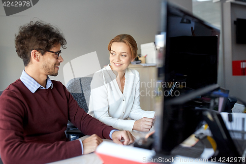 Image of happy business team working at office