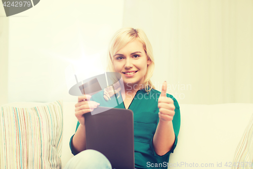 Image of happy woman with tablet pc and credit card