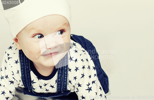 Image of little cute baby toddler on carpet isolated close up smiling ado