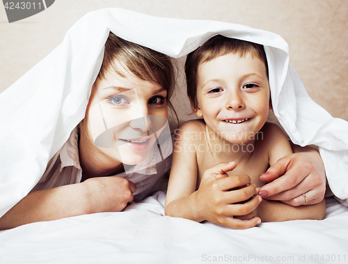 Image of young blond woman with little boy in bed, mother and son, happy 