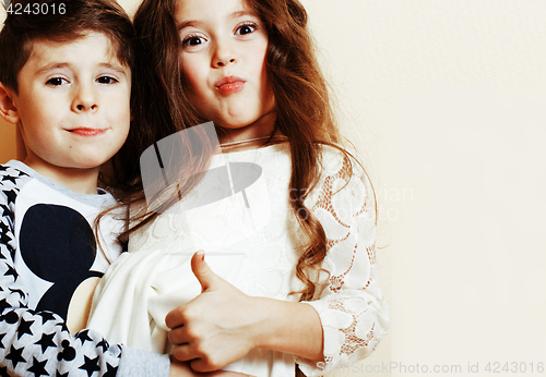 Image of little cute boy and girl hugging playing on white background, ha