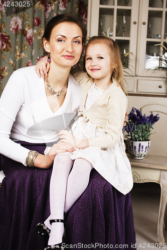 Image of young mother with daughter at luxury home interior vintage