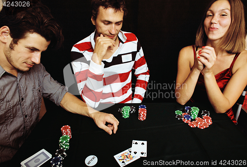 Image of young people playing poker off-line tournament, friends party co