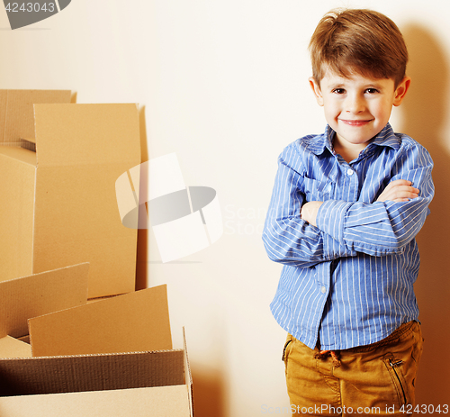 Image of little cute boy in empty room, remoove to new house. home alone,