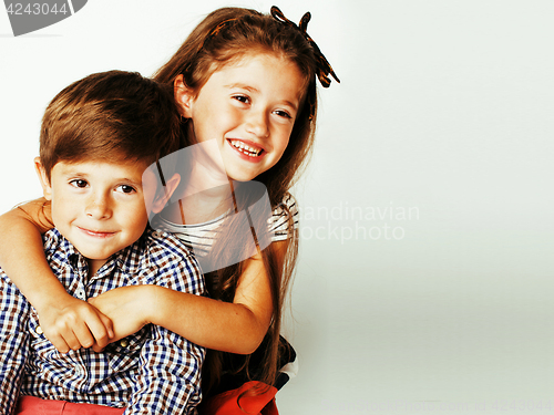 Image of little cute boy and girl hugging playing on white background, ha