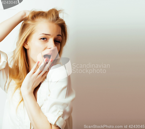 Image of young blond woman on white backgroung gesture thumbs up, isolate