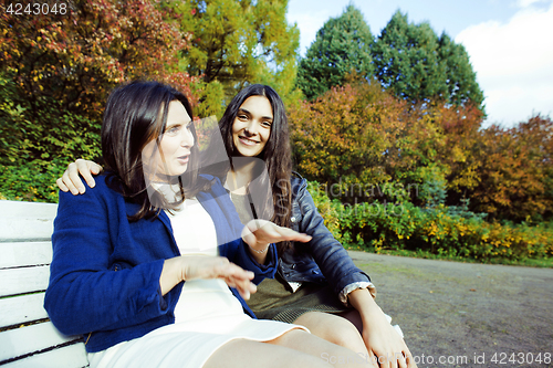 Image of mature real mother with daughter outside autumn fall in park