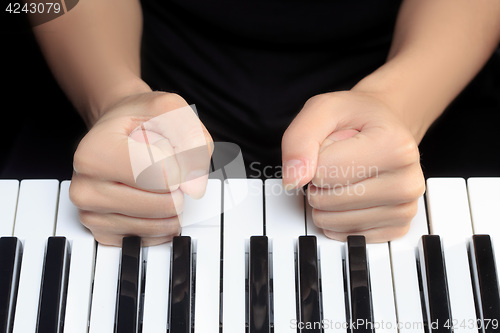 Image of Girl\'s hands on the keyboard of the piano