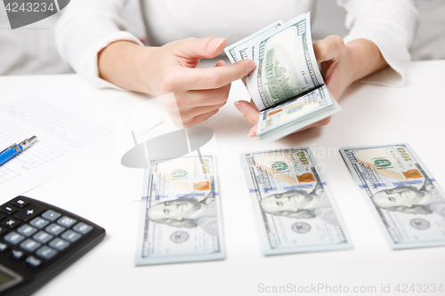 Image of Hands counting money, close up