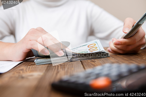 Image of Hands counting money, close up