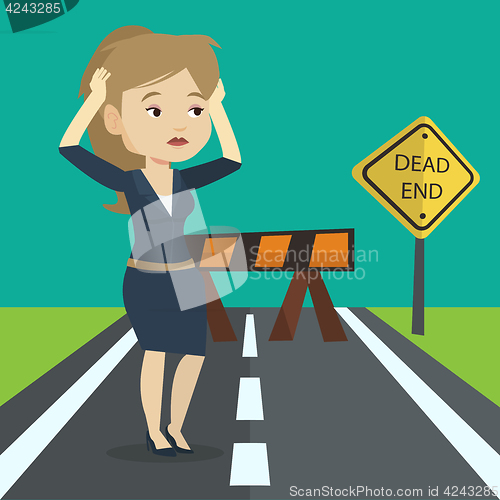 Image of Businesswoman looking at road sign dead end.