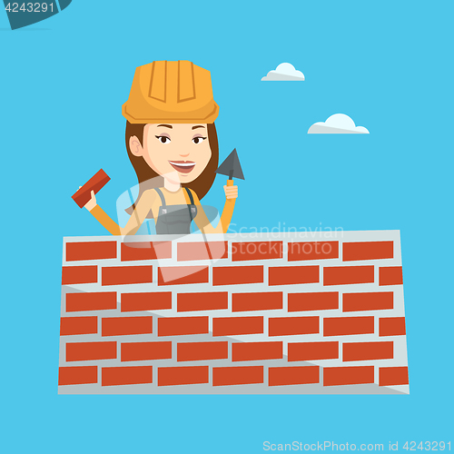 Image of Bricklayer working with spatula and brick.