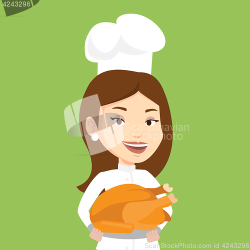 Image of Chief cook holding roasted chicken.