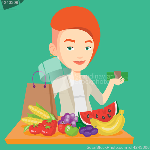 Image of Woman standing at the table with shopping bag.