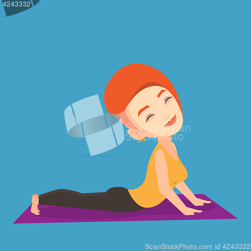 Image of Woman practicing yoga upward dog pose.