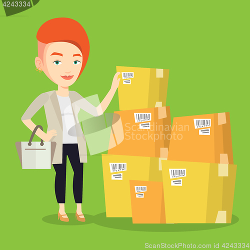 Image of Business woman checking boxes in warehouse.