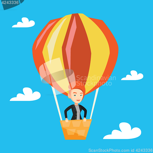 Image of Young woman flying in hot air balloon.