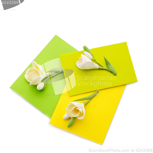 Image of Close up of three yellow envelope with flowers