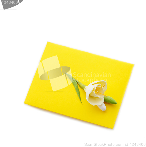 Image of Close up of yellow envelope with flower