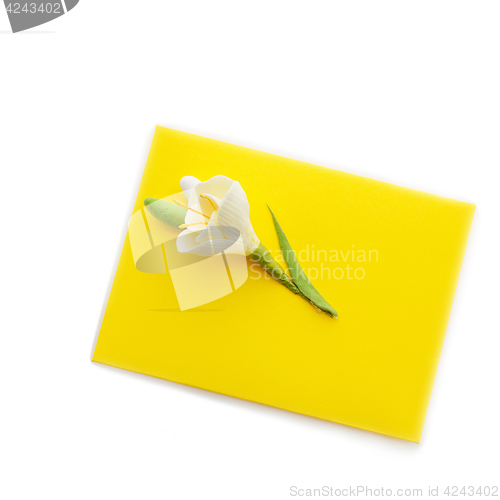 Image of Close up of yellow envelope with flower