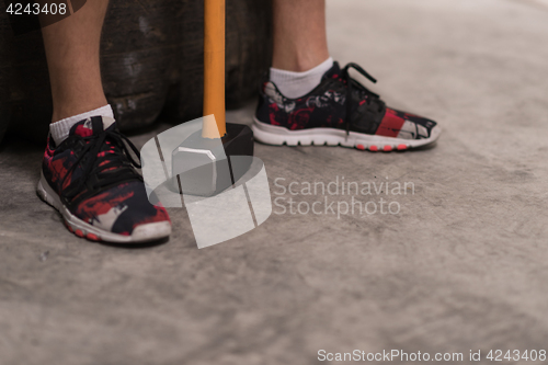 Image of man after workout with hammer and tractor tire