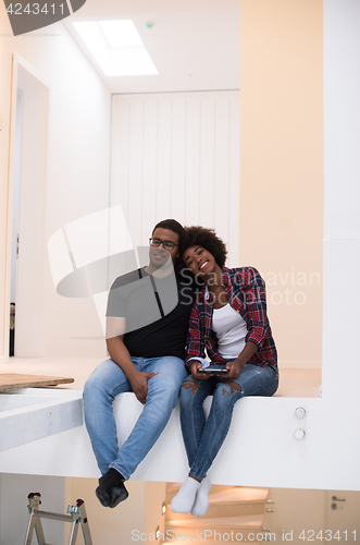 Image of couple having break during moving to new house