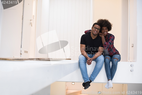 Image of couple having break during moving to new house