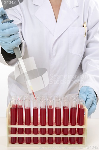 Image of Scientist using pipette to extract samples