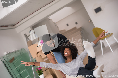 Image of African American couple  playing with packing material