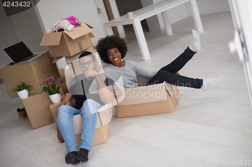 Image of African American couple  playing with packing material