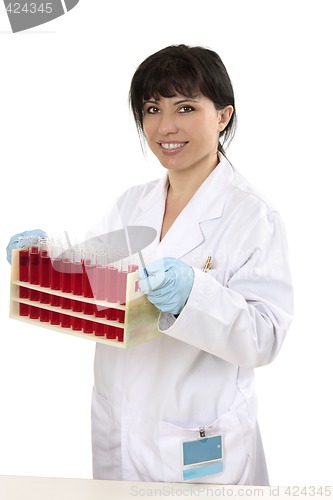 Image of Female carrying rack of test tubes