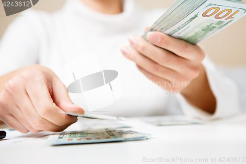 Image of Hands counting money, close up