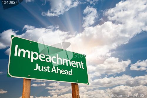 Image of Impeachment Green Road Sign with Dramatic Clouds and Sky