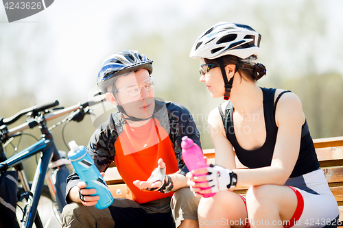 Image of Cyclists in helmets with water