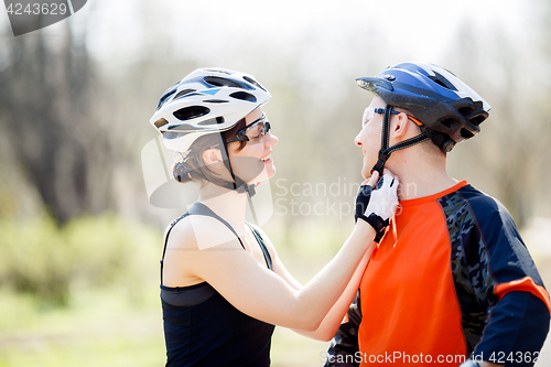 Image of Two happy cyclist wear helmet