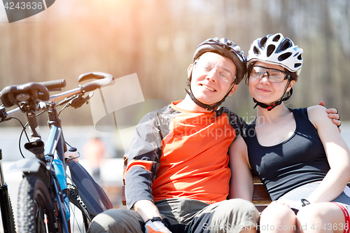 Image of Photo of bicyclists on bench