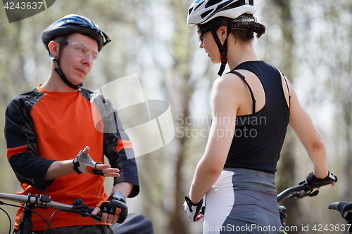 Image of Young guy, girl with bicycles