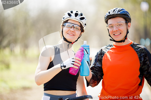 Image of Cyclists with water in hands